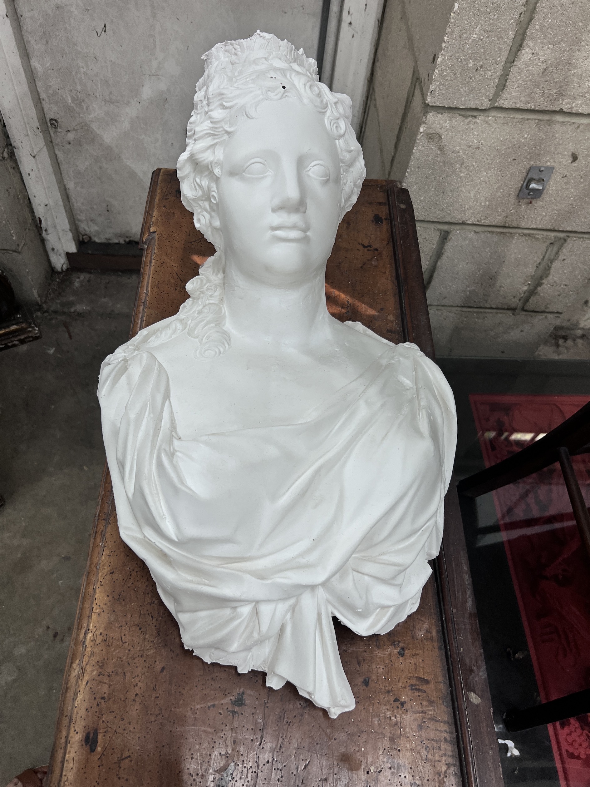 Two cast plaster wall applique busts, width 36cm, height 64cm